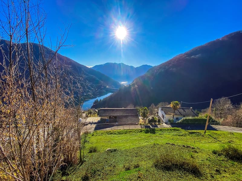 Mountains, trees, houses, lake, mountains with snow
