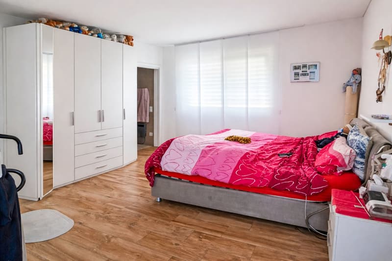 large bed, white closet, wooden floor, nightstand