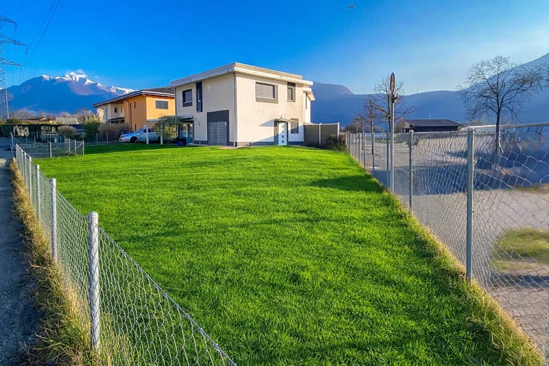 2 story house, white, grey accents, garage, lawn, mountains in the background