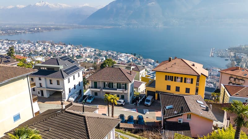Row of houses with mountain and lake view, parking place for each house, balconies