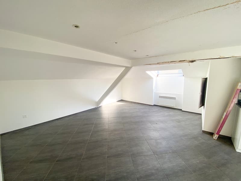 Empty room, white walls, tiled floor, sloping ceiling, window, air conditioning unit