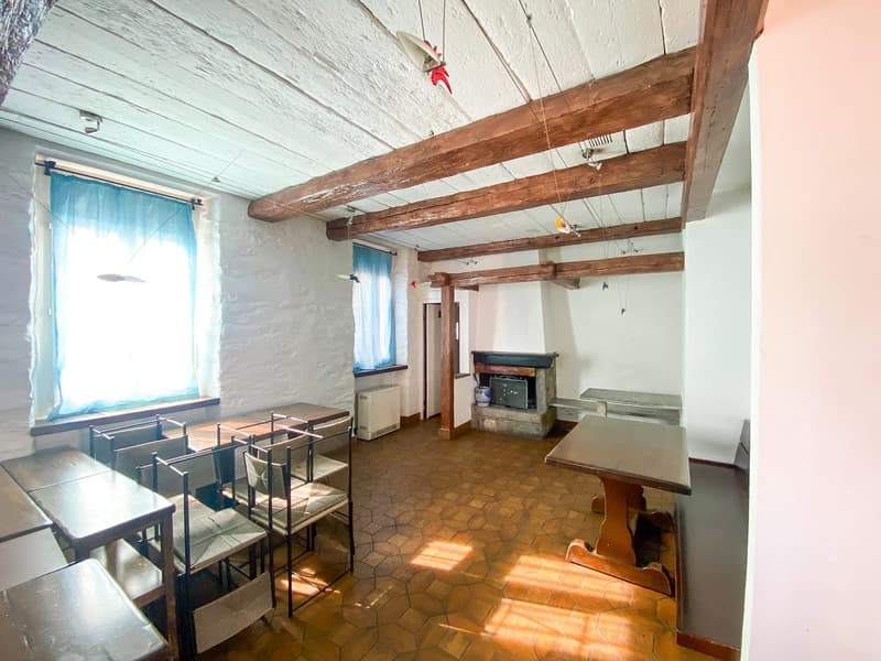 wooden beams ceiling, fireplace, tables, chairs, windows, tiled floor