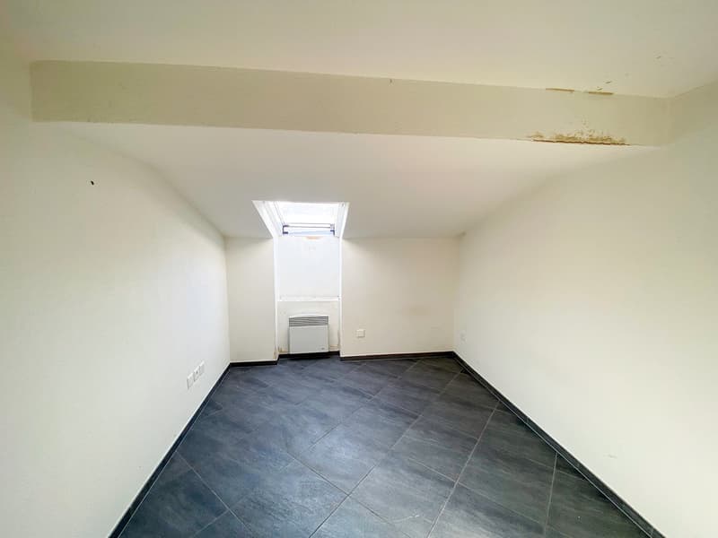 Empty room with white walls, tiled floor, a ceiling fan, an open window, and an electric heater.