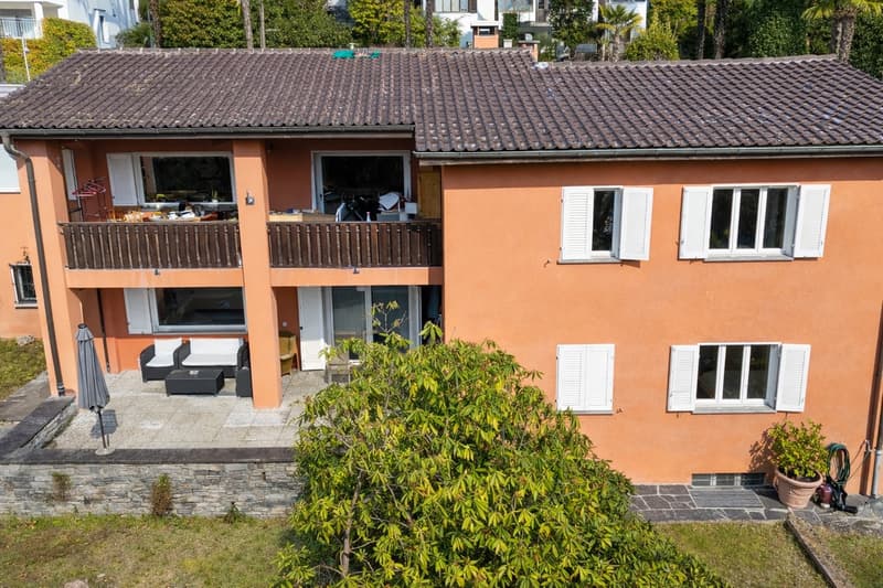 2 story house, balcony, terracotta roof, terracotta walls, glass doors