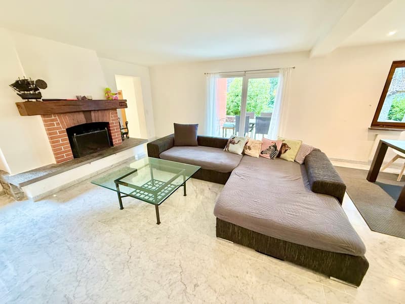 L-shaped couch, glass coffee table, fireplace, sliding glass doors