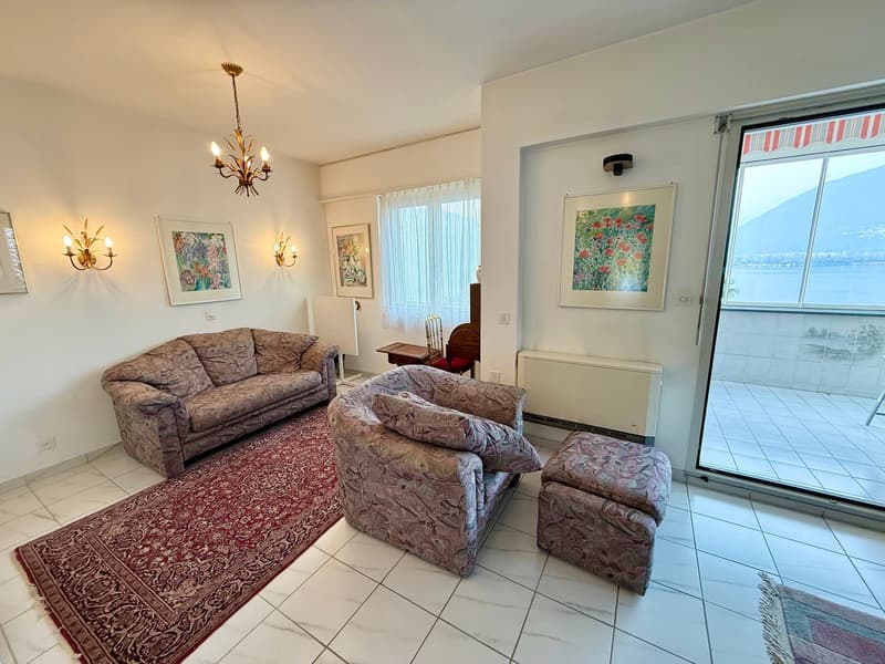 two couches, two armchairs, ottoman, rug, chandelier, wall art, sliding glass door, balcony, view