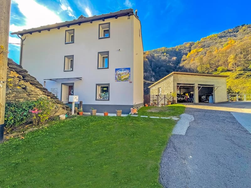 2 story house, white exterior, multiple windows, garage, driveway, garden, mountain view