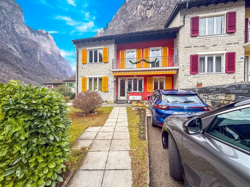 red and white building, balcony, pathway, car parked in front