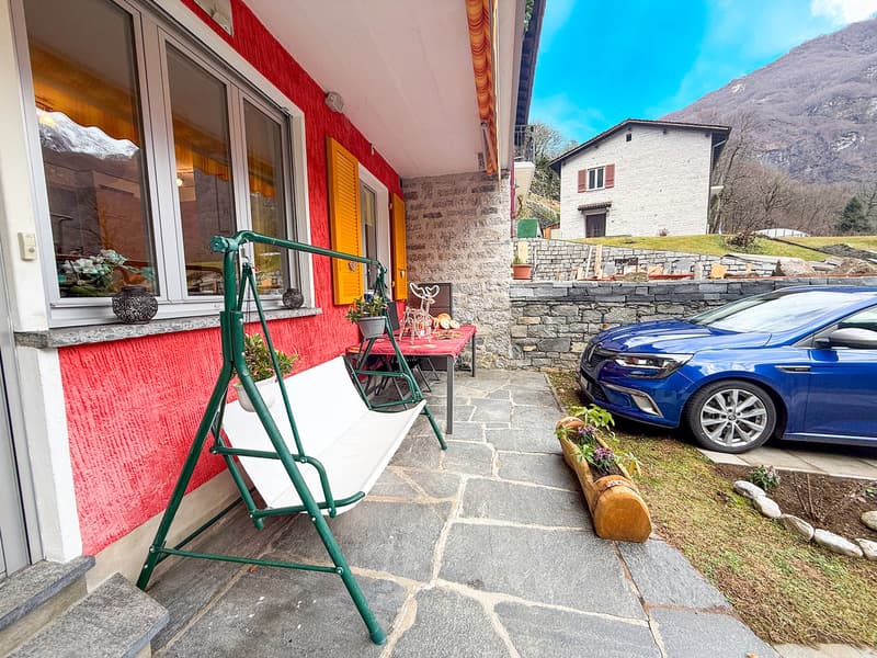 Red house, yellow shutters, swing, blue car, mountain view
