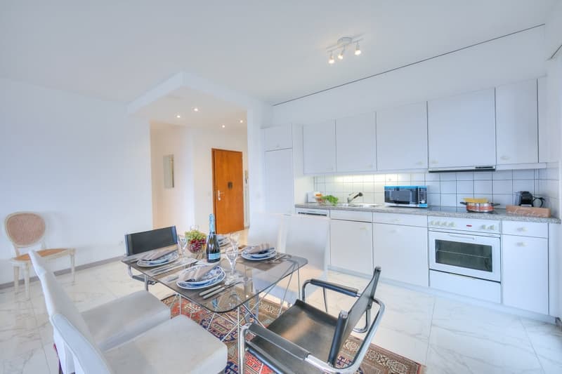 modern white kitchen, granite countertop, oven, microwave, dining table with chairs, dining area