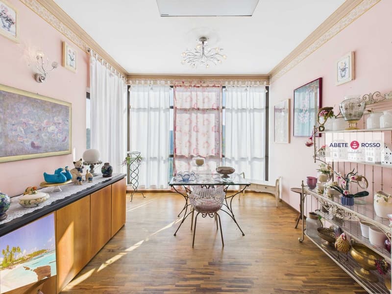 pink walls, large windows, wooden floor, glass top dining table with chairs, white curtains, decorative items, painting on the wall
