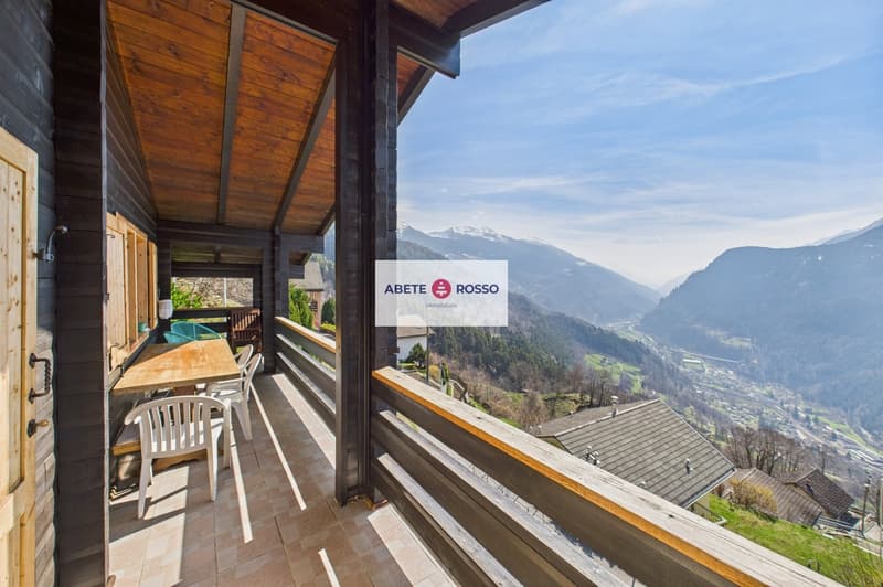 wooden balcony with table and chairs, wooden railing, wooden floor, view of mountains