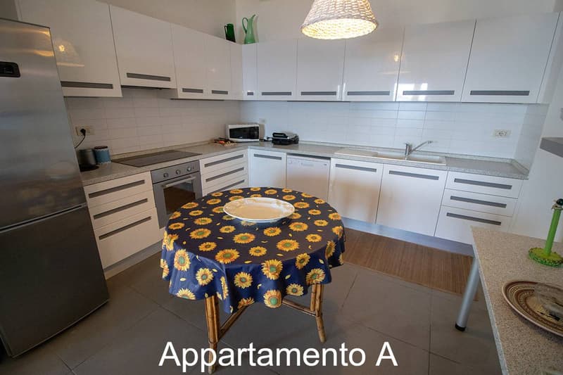 modern, white cabinets, stainless steel appliances, dishwasher, microwave, gas stove, refrigerator, tiled floor, light