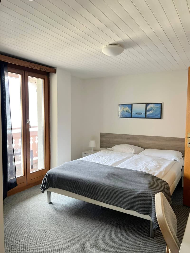 Double bed, bedside tables, lamps, double-glazed window, carpet, picture frame, sliding door