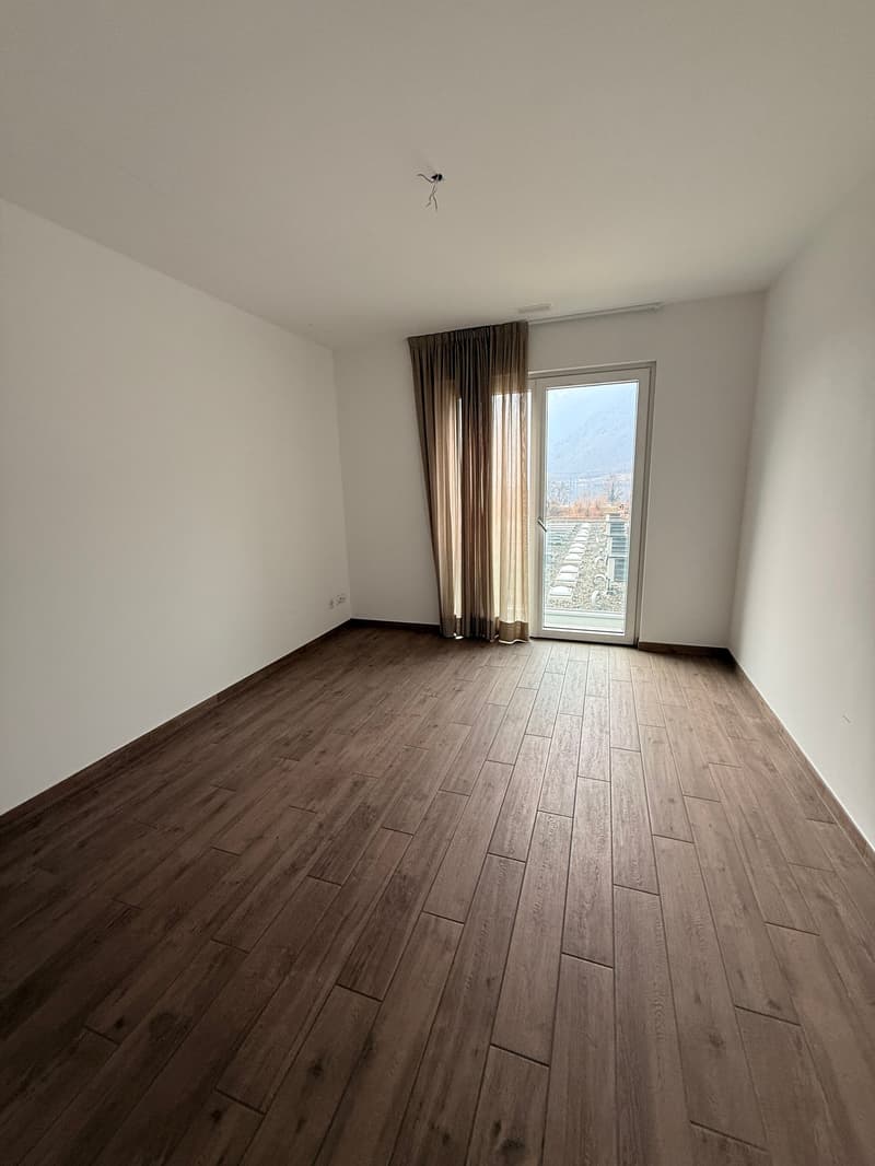 empty room, hardwood floor, large glass doors with curtain