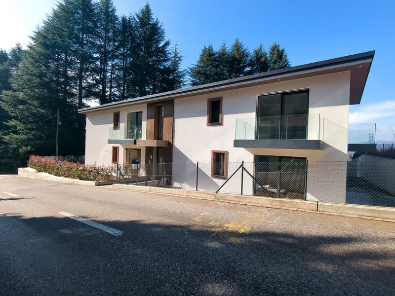 Modern design, 2-story house, white exterior, glass windows, balconies with railings, fenced entrance.