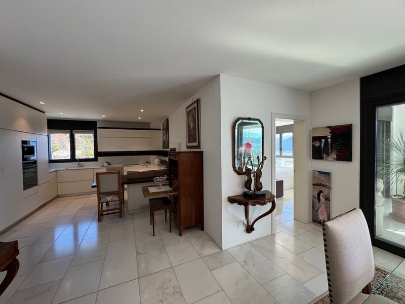modern kitchen with dining area, white tile floor, wooden shelves, dining table and chairs, glass table and chair, mirror, paintings, balcony
