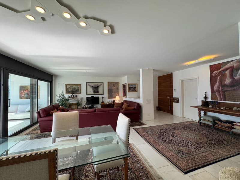 modern living room, glass table, white chairs, couches, artwork on walls, large windows, decorative objects