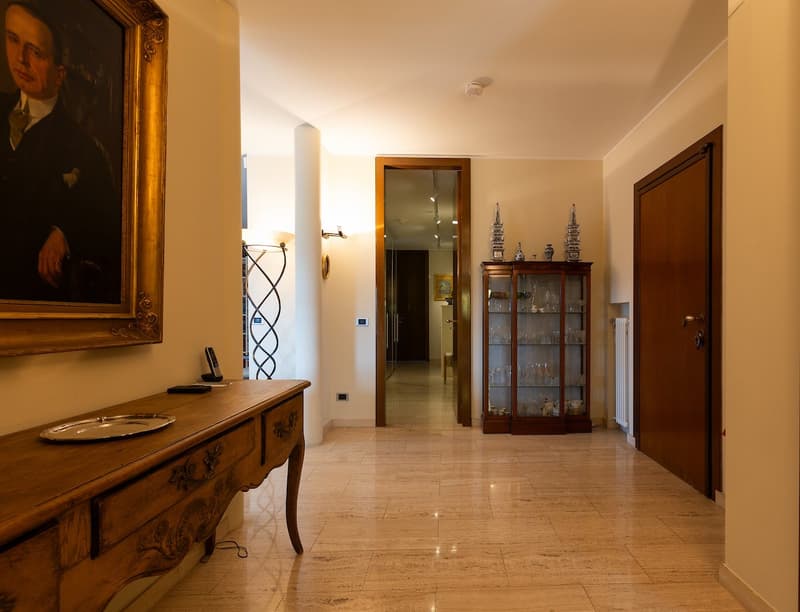 marble floor, wooden desk, decorative items, picture frame, lamp, radiator