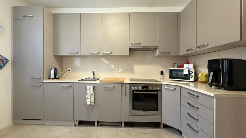 modern kitchen, stainless steel appliances, gray cabinets, wooden countertops, electric kettle, microwave, sink, faucet, towel, coffee machine, gas stove, oven