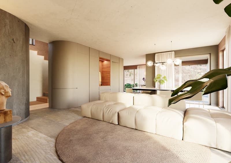 Living room with L-shaped sofa, round rug, large windows, pendant lights, side table with sculpture, and plants.