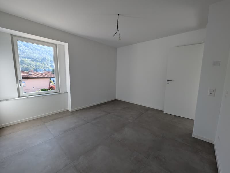 empty room, white walls, gray tile floor, large window, door