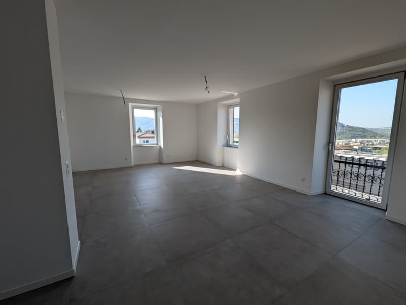 empty room, white walls, tiled floor, large windows, balcony with railings