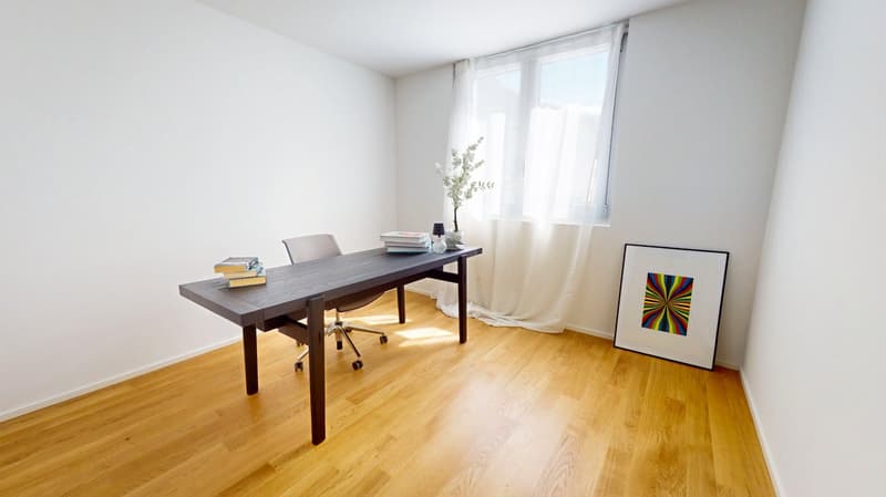 wooden floor, white walls, desk, office chair, books, picture frame, window with white curtains