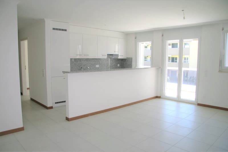 modern kitchen with white cabinets, granite countertop, sink, sliding glass doors, white tiles