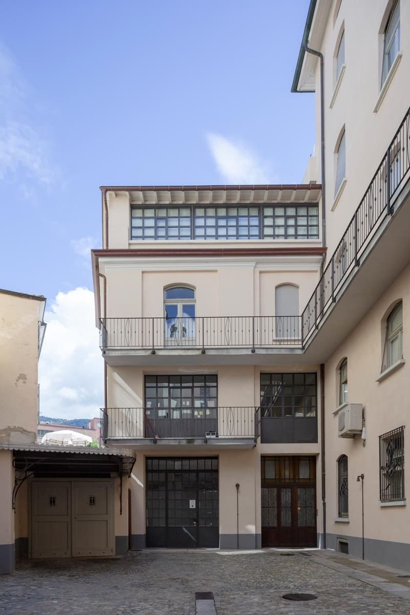 two floors, balconies, garage, entry doors, windows, iron railings, AC unit