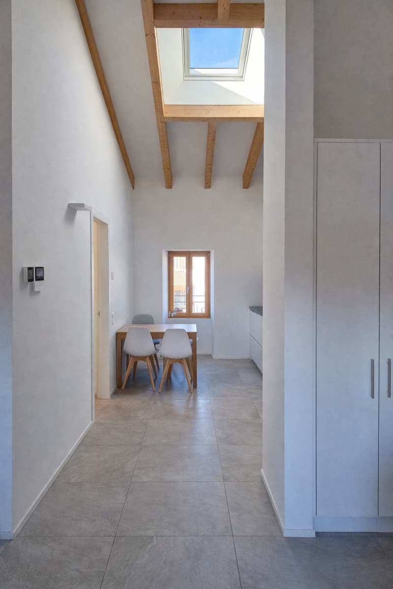 dining table with 4 chairs, wooden beams, tile flooring, ceiling with skylight