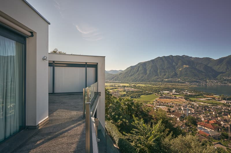 Building exterior, balcony with railing, expansive views of mountains and valley.
