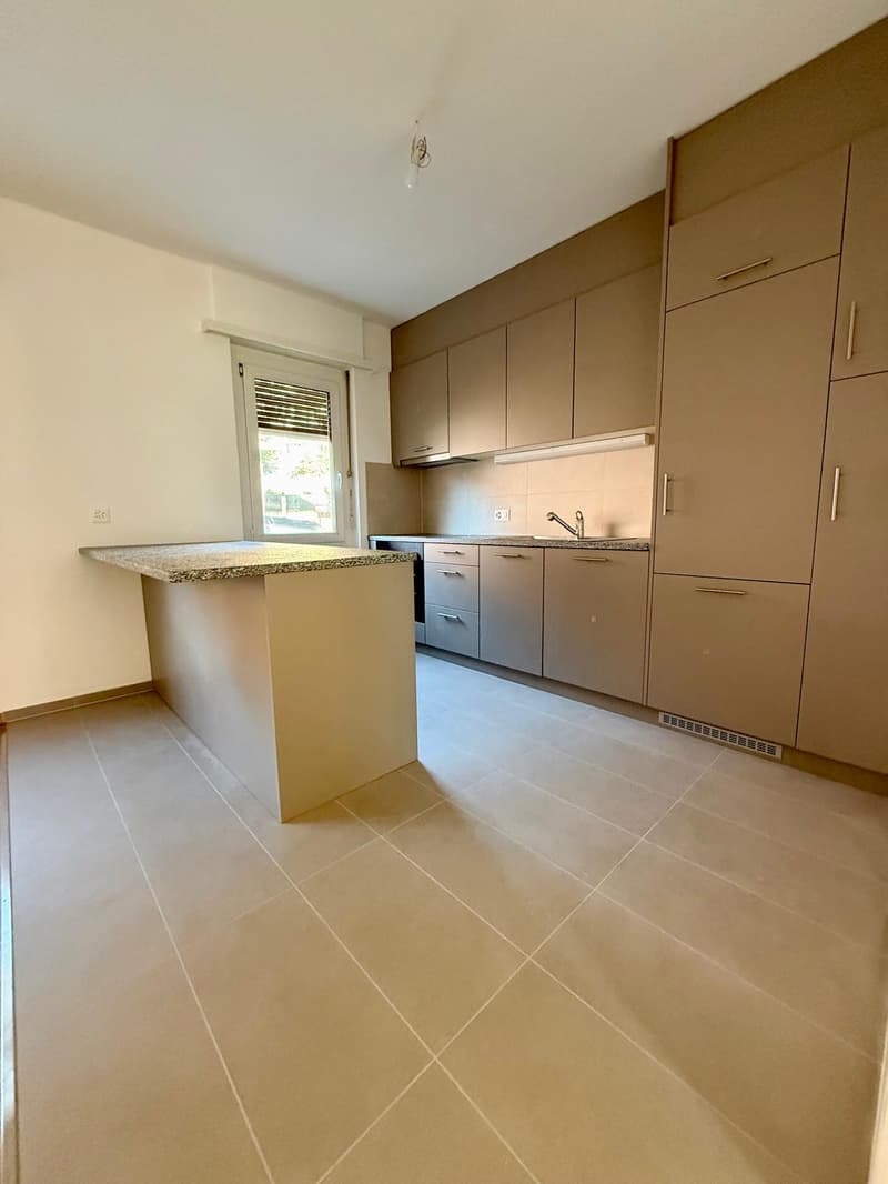 white cabinets, granite countertop, kitchen island, sink with faucet, tiled floor, power outlet, open window