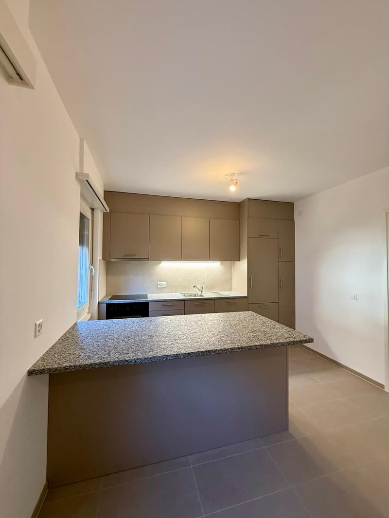 Large countertop, tiled backsplash, built-in cabinets, white and gray decor, sink, dishwasher, oven, tiled flooring, under cabinet lighting