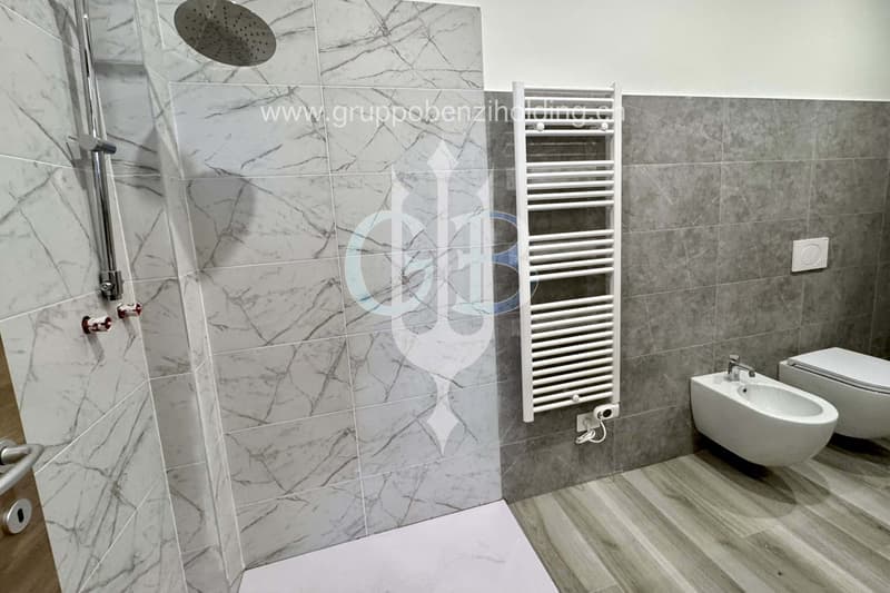 shower area, marble tiles, toilet, bidet, wall radiator