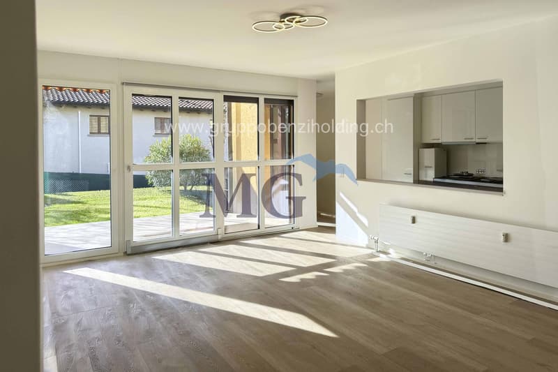 empty living room, glass doors to terrace, white walls, modern lighting, wooden floor