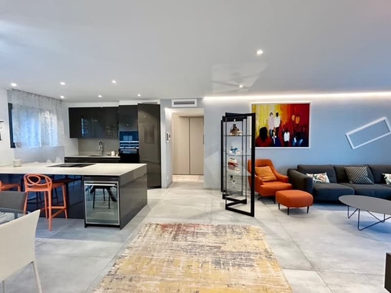 modern style, white walls, large windows, kitchen with breakfast bar, center island, living room with large sofa, coffee table, wall art, rug, orange chairs, round dining table, ceiling fan