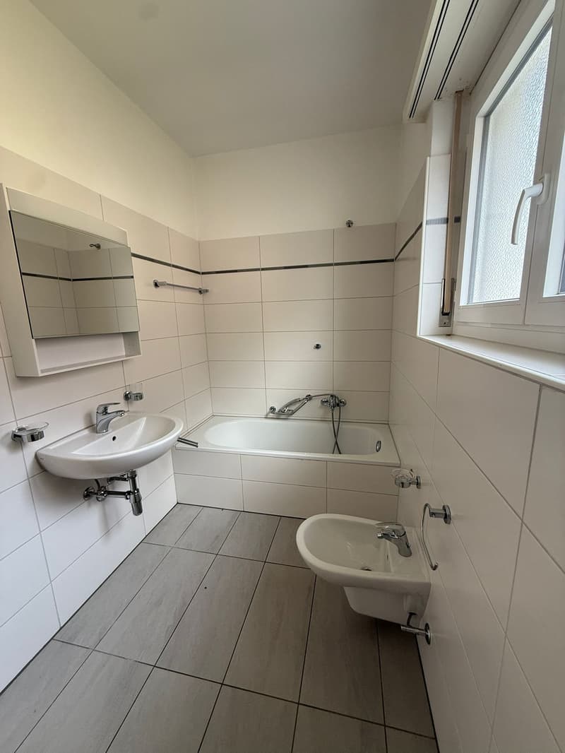 white tiles, bathtub, sink, window, mirror