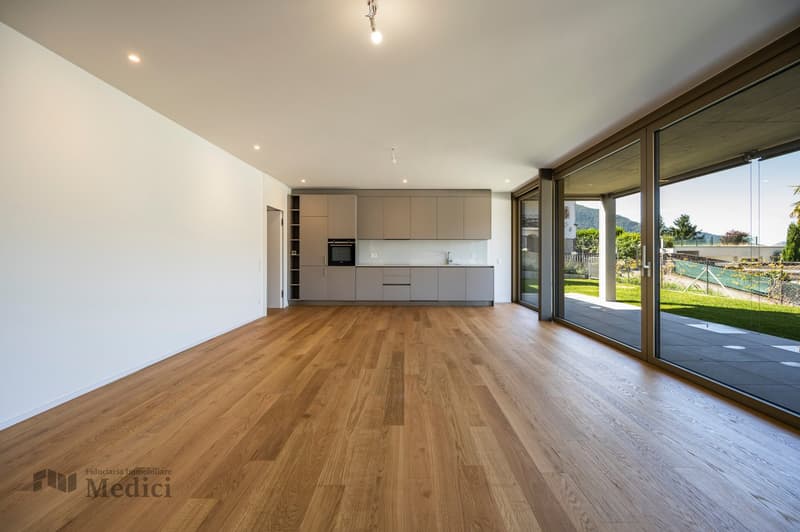 modern kitchen with white cabinets, wooden floors, large glass sliding doors leading to terrace, panoramic mountain view