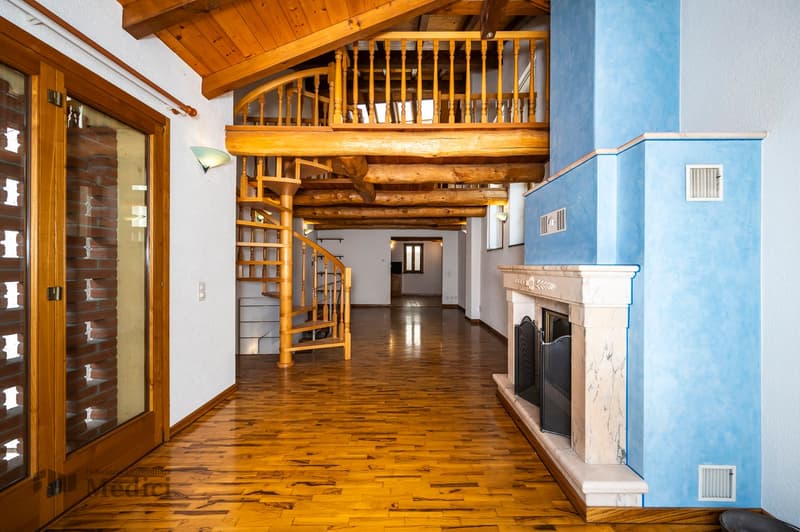 Wooden ceiling, wooden spiral staircase, blue wall, wooden floor, fireplace, spiral staircase