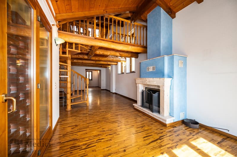 Wooden floor, blue chimney, fireplace, spiral staircase, wooden beams on ceiling