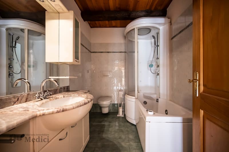 Spacious bathroom, marble countertop, separate shower and bathtub, modern white fixtures, wooden beams