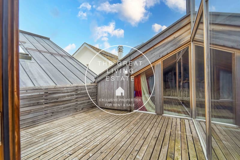 Exterior wooden terrace, sliding glass doors, wooden fence, blue sky