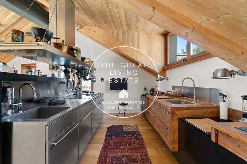modern kitchen with stainless steel appliances, wooden counters, and a rustic rug