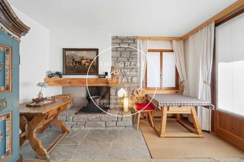 Stone fireplace, wooden desks, wooden tables, stone flooring, wooden chair, desk with cushion