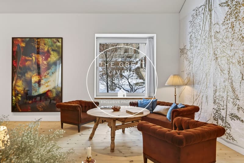 modern living room with large window view, brown couches, wooden coffee table, lamp, artwork