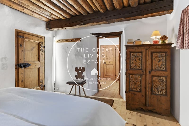 wooden bed, white sheets, old wooden chair, old wooden cabinet, wooden wall, wooden door, wooden ceiling
