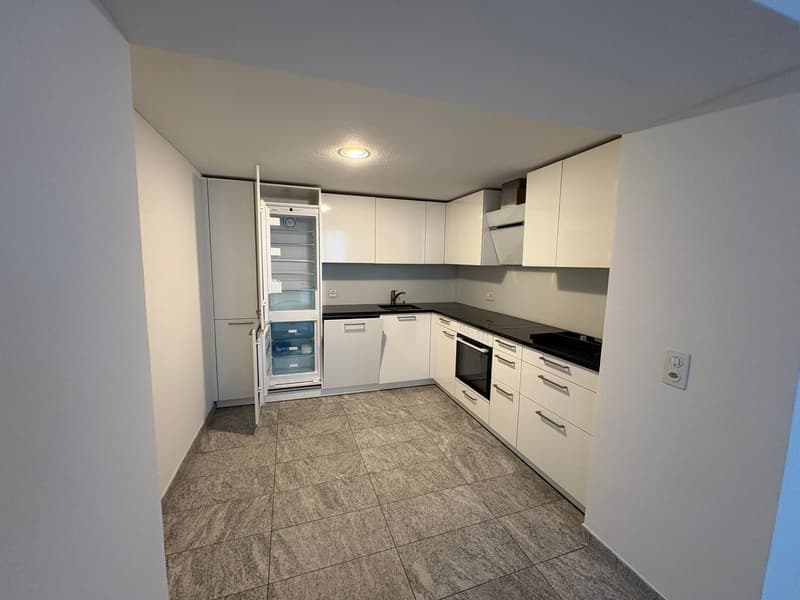 White cabinets, tiled floor, sink, refrigerator, electric range, dishwasher, power outlet.