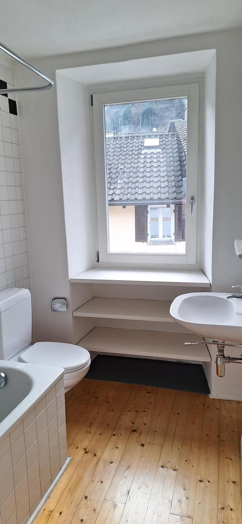 Bathroom: Tiled walls and floor, White toilet, bathtub, sink, shower curtain, window
