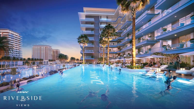 A modern building complex with numerous terraces and balconies, large swimming pool at the front